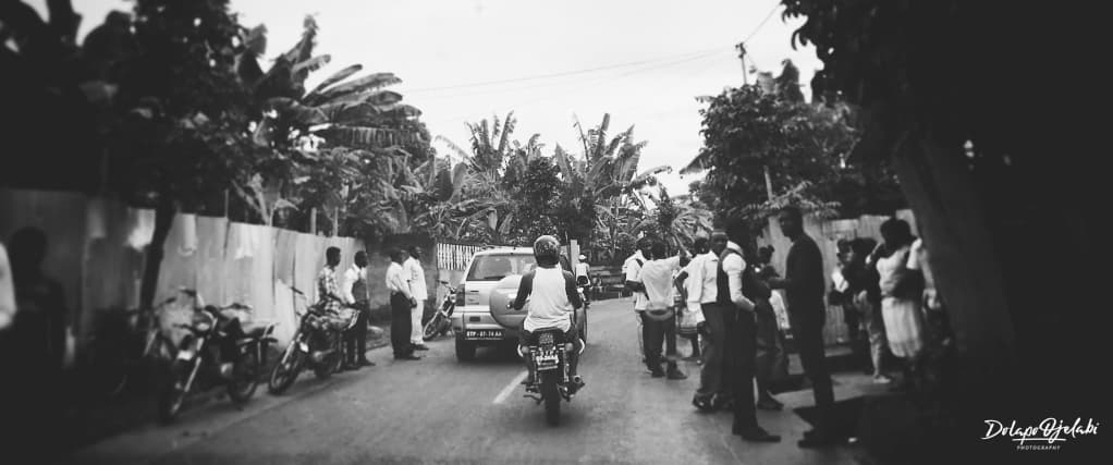 A crowd gathered along a tree-lined road — from the BW Studies series